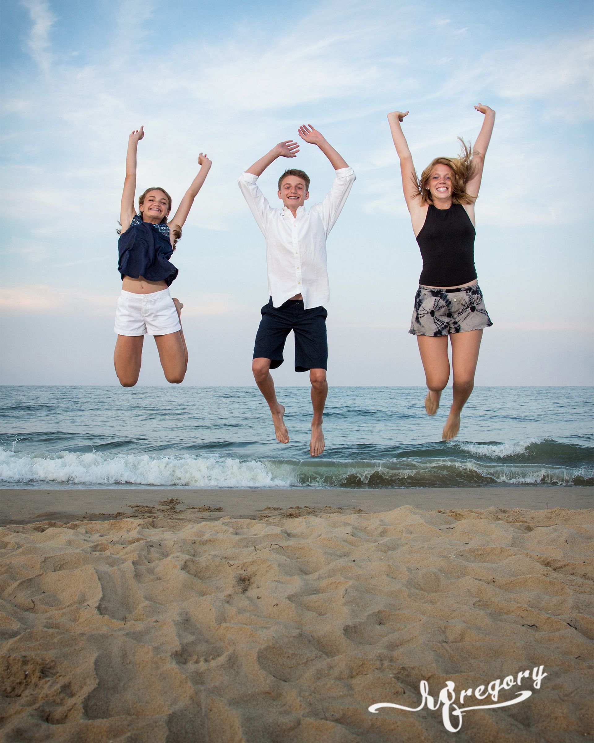 BROWN family jumping in air beach photography