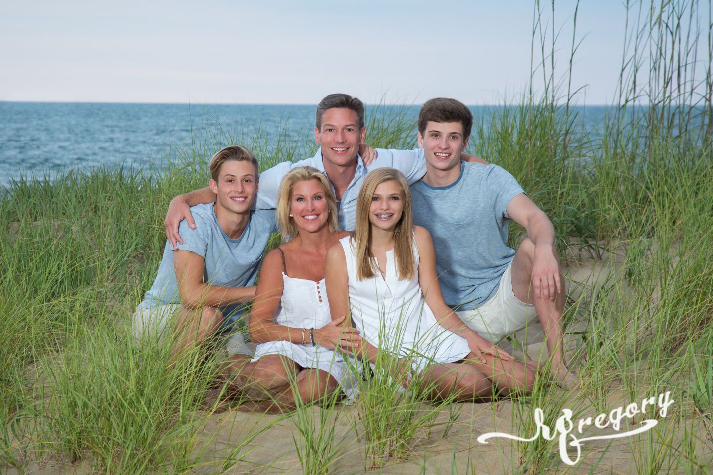 Mayer family portrait on beach in grass va