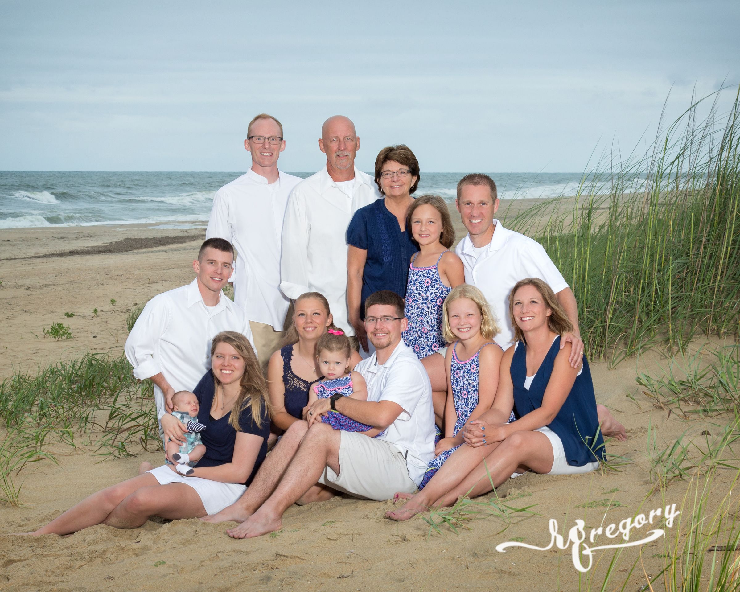 Rader family portrait on beach ocean in back