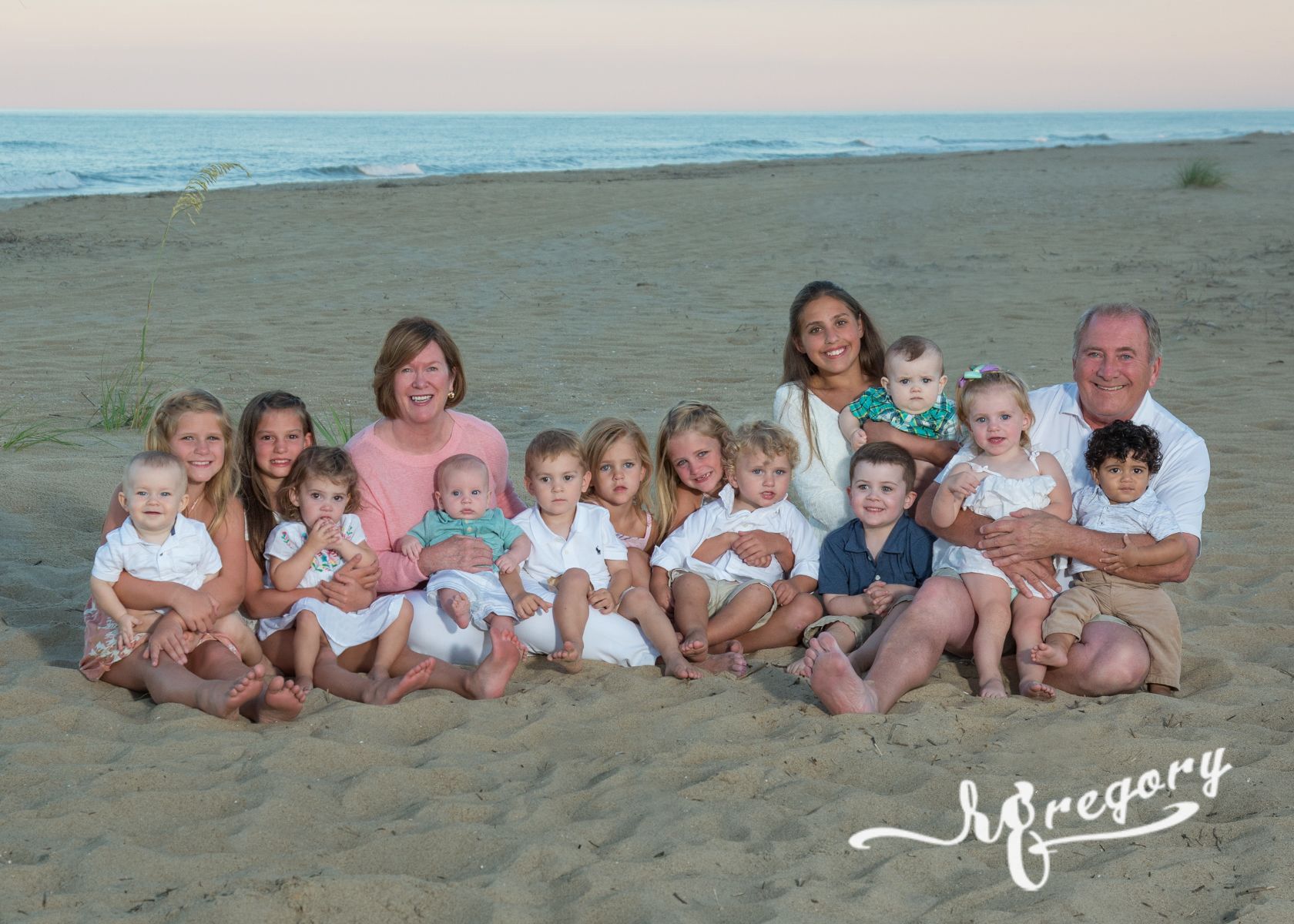 Woltjen family and children sitting on beach pic